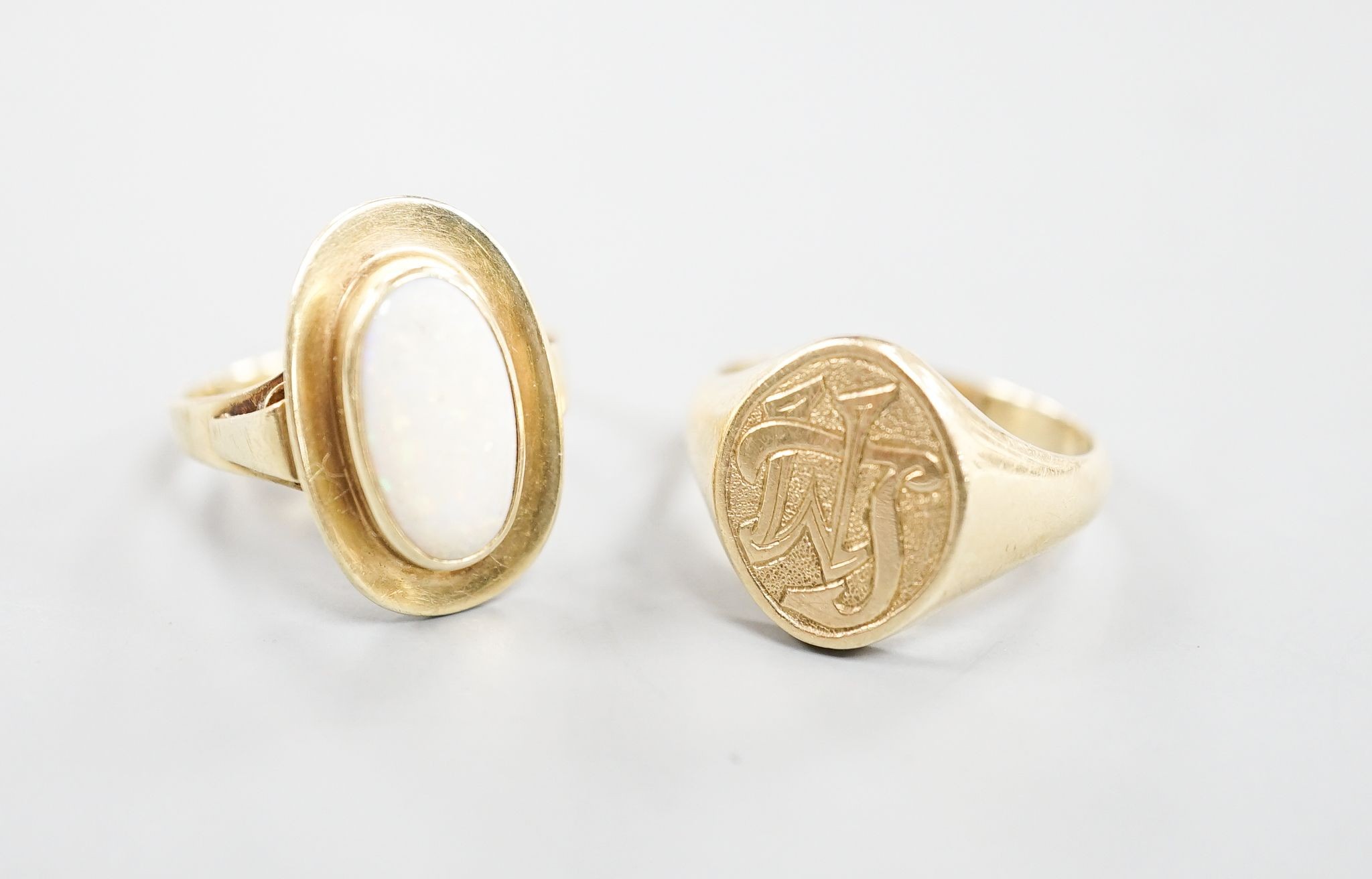 A 585 yellow metal signet ring, with engraved monogram, size O/P and a 585 and white metal and white metal oval dress ring, size O, gross weight 12.6 grams.